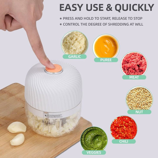 Hand pressing top of garlic chopper, with vegetables being blended inside.