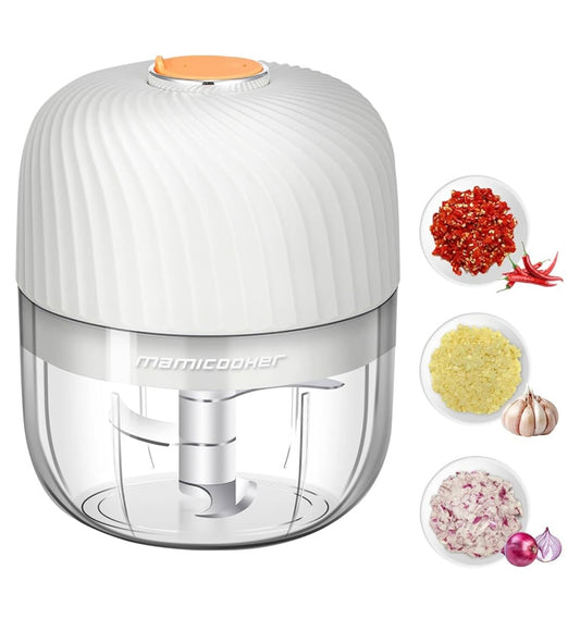 Mini garlic chopper with white lid and clear container, surrounded by chopped garlic, onion, and chili.